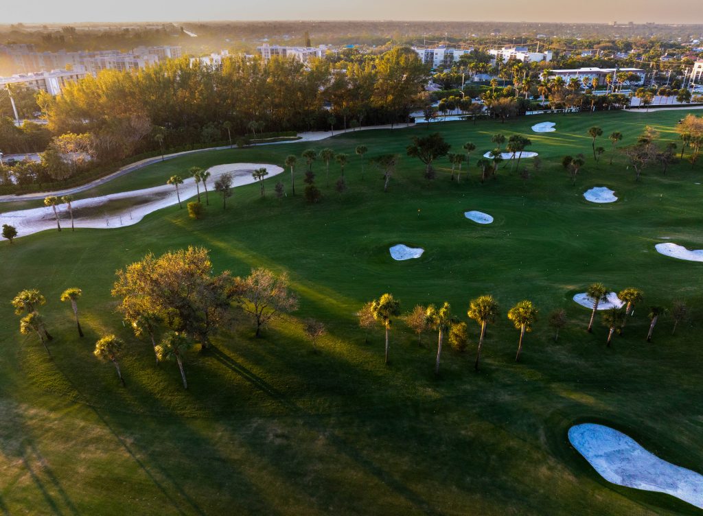 Aerial photo of the Royal Palm Yacht and Country Club golf course and driving range at sunset in Boca Raton Florida